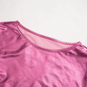 Detail of pink metallic crop top showing stitching and shiny reflective fabric texture