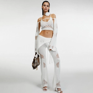 Detail of white crochet knit set with hollow-out texture and intricate woven patterns