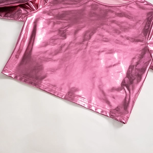 Detailed close-up of metallic pink crop top fabric with reflective mirror finish and stitching