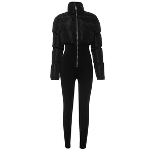 Close-up of black quilted puffer jumpsuit with high collar and silver metallic zipper