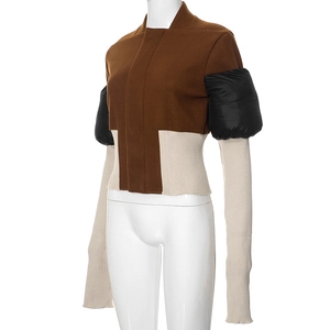 Detail of slim-fit jacket with contrast patchwork and black quilted bubble sleeves