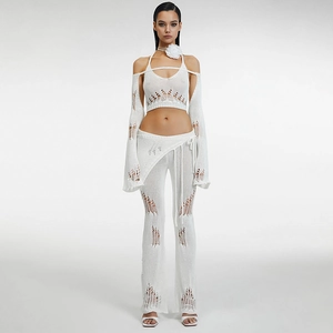 Detailed knit texture of white crochet four-piece set with hollow patterns and soft fabric