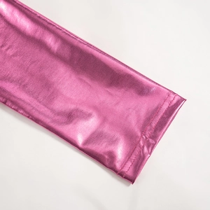 Detail of the bright metallic pink fabric with double-needle stitching and reflective texture