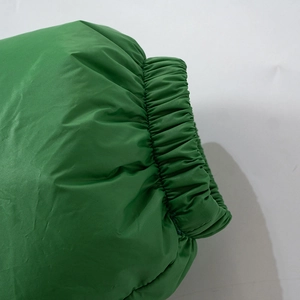 Detail of elastic ribbed cuff on green puffer jacket with windproof fabric
