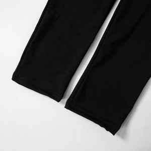 Detailed close-up showing the double-stitched hem and fabric texture of black jumpsuit