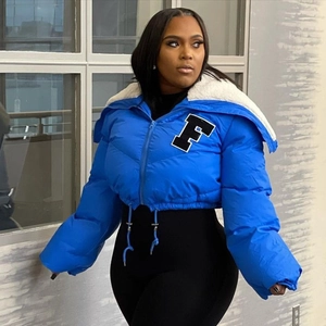 Close-up of blue cropped puffer jacket featuring a white F patch and sherpa fleece collar