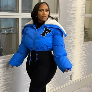 Detail of blue quilted puffer jacket with white faux fur collar and letter F embroidery