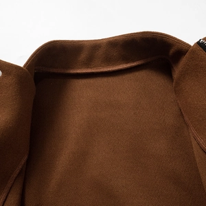 Macro shot of dark brown outerwear featuring a stand collar and honeycomb textured lining