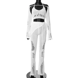 White distressed knit four-piece set with halter top, cardigan shawl and wide-leg trousers