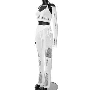 Detail view of white distressed knit four-piece set with halter top and cutout sleeves