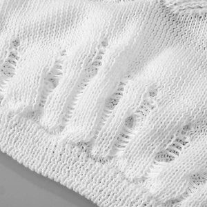 Detailed macro view of white crochet knit fabric with hollow mesh and wave pattern