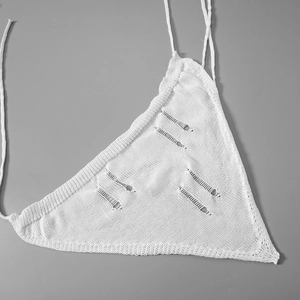 Detail of white knit triangle halter top featuring boho distressed hollow out pattern