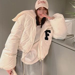 Detail of white hooded jacket showing black plush letter F embroidery and fleece lining