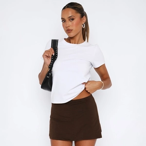 Detail of white crew neck tee paired with dark brown elastic waist mini skirt set