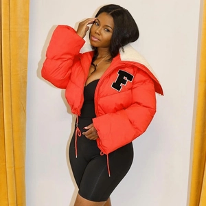 Detailed view of red puffer jacket with white faux shearling collar and F letter embroidery