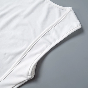 Detail of the high-quality stitching and ribbed white fabric on a sleeveless dress