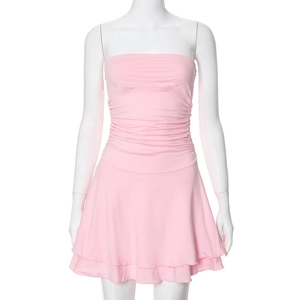 Detail view of pink ruched tube dress showing layered ruffle hem and textured fabric