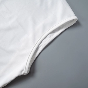 Detailed close-up showing double-needle stitching on the white dress hem or cuff edges