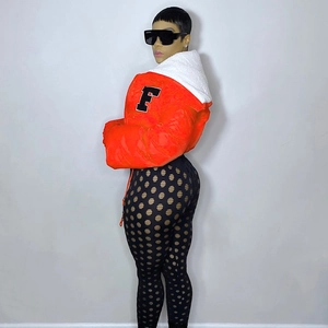 Detail of orange hooded puffer jacket with white faux fur collar and black letter patch