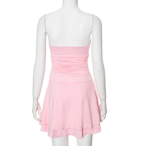 Detail view of pink backless dress with ruched waist and layered hem on a white mannequin
