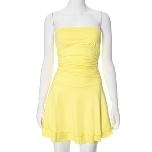 Detail of elegant bright yellow strapless mini dress with pleated bust and ruffled hem