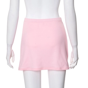 Detail of light pink mini skirt showing elastic waistband and soft knitted fabric texture