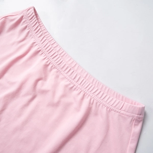 Detail of light pink elastic waistband showing fine stitching on sports mini skirt
