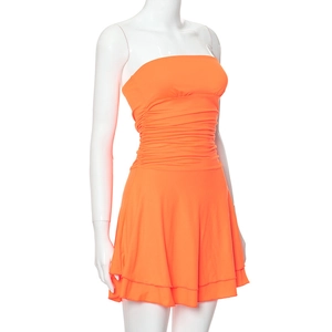 Detail of bright orange strapless ruched dress with layered ruffle hem on mannequin