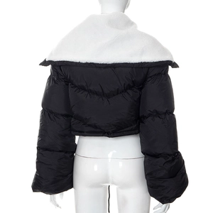 Close-up of black quilted puffer jacket featuring a plush white fleece collar detail