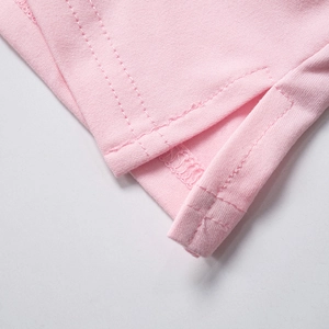 Detail of pink stretch knit skirt showing side slit and neat double-needle stitching