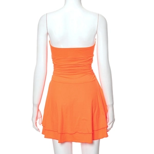 Detail view of the orange strapless mini dress featuring elastic ruched back and layered hem
