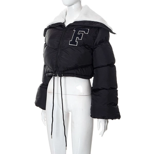 Detail view of cropped black puffer jacket featuring white sherpa collar and F embroidery