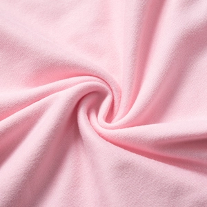 Detailed close-up of soft pink high-density knit cotton fabric with a smooth texture