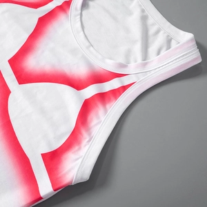 Detailed close-up of the red geometric print and neckline stitching on a summer white tank dress