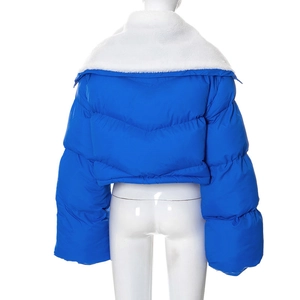 Back view of a royal blue cropped puffer jacket with a large white faux fur collar