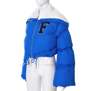 Detail of bright blue padded jacket with white faux fur collar and black letter F patch