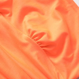 Detail shot of bright orange ruched fabric with premium elastic knit texture