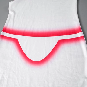 Detailed view of white sleeveless dress showing a red gradient bikini print on knit fabric