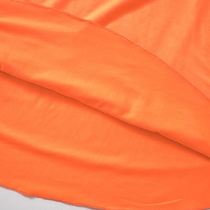 Close-up of orange dress hem with professional edge stitching and smooth fabric detail
