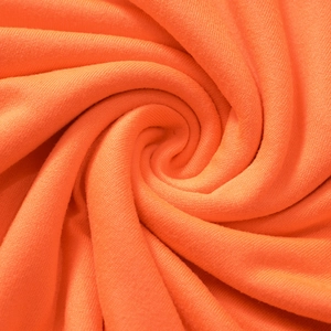 Close-up of vibrant orange ribbed knit fabric showing soft texture and fine stitching