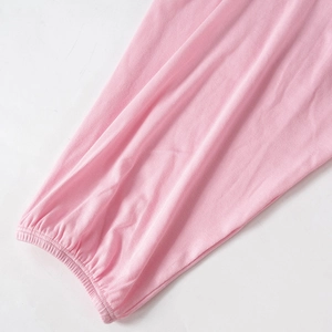 Detailopname van de lichtroze geribbelde elastische manchetten en zachte gebreide stof jumpsuit