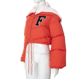 Detail of orange puffer jacket featuring white sherpa collar and embroidered F patch