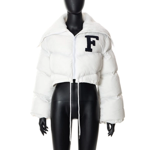 Close-up of white padded jacket with varsity F letter embroidery and faux fur collar