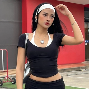 Women's trendy black short sleeve crop top with white layered design and silver jewelry