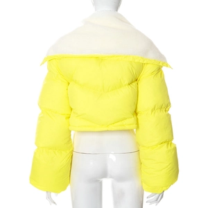 Detail of yellow puffer jacket featuring white faux fur collar and V-shaped quilting