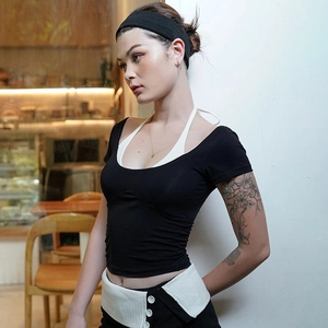 Women's backless faux two-piece black and white t-shirt in cafe setting lifestyle view