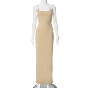 Detail shot of the side slit and hemline on a slim-fit nude sleeveless maxi dress