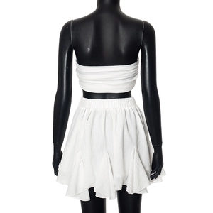 Back view of a white two-piece chiffon set featuring a bandeau top and pleated mini skirt