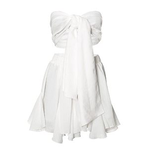 Detail of white two-piece chiffon set featuring a large bow bandeau top and ruffled mini skirt
