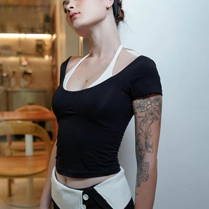 Slim fit black T-shirt with white layered halter neck detail and open back design